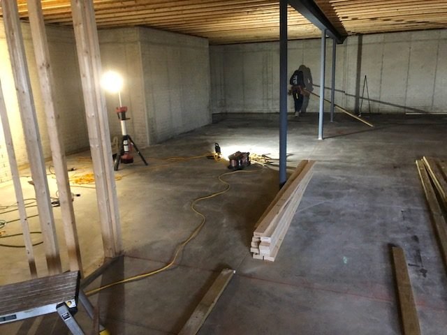 Basement framing with a steel beam and posts carrying the floor above