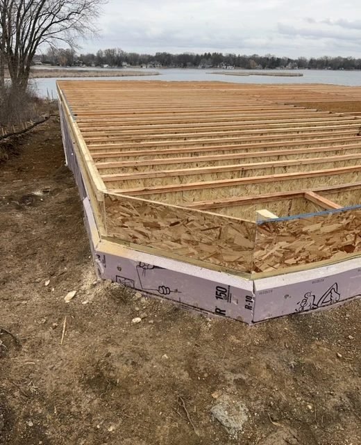 Subfloor decked over the foundation of a lakeside new build