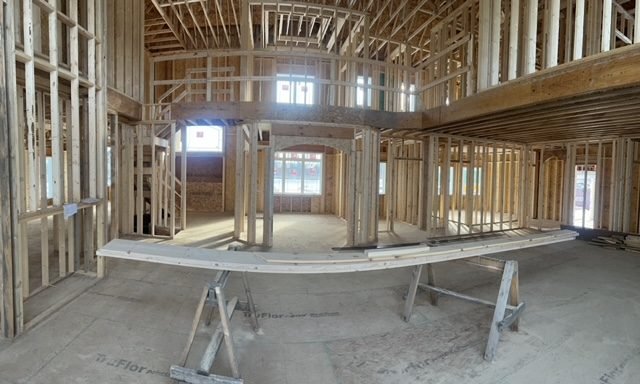 Open-plan interior framed out, with window and door openings set