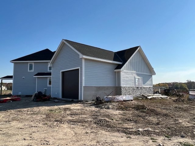 Completed siding on a gabled new build, corner boards and fascia trimmed out