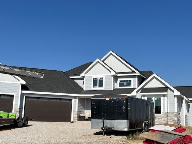 Front elevation of a finished home with porch, board-and-batten, and lap siding