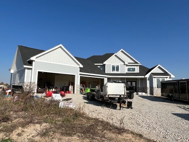Finished siding and trim on a new ranch home with attached garage