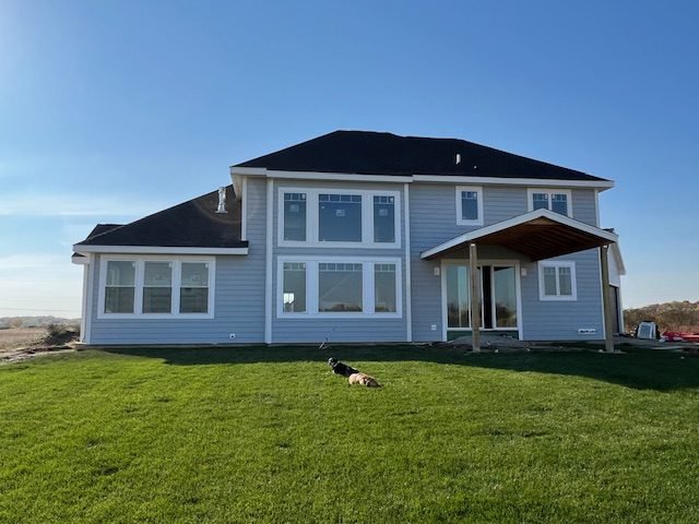 Two-storey home with siding, trim, and windows complete, lawn established