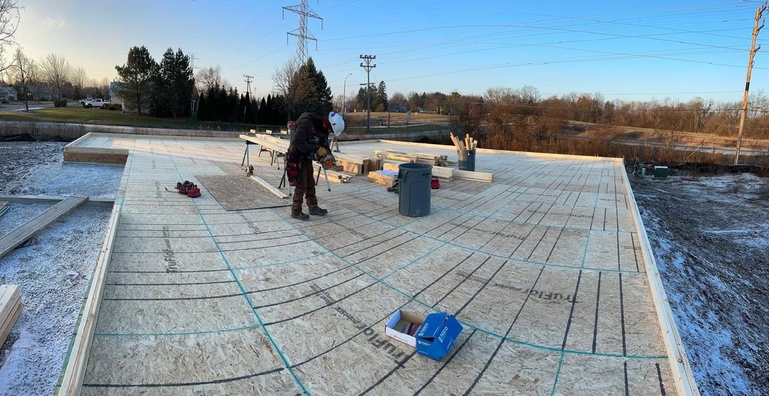 Crew setting rebar and forms on a slab before the pour