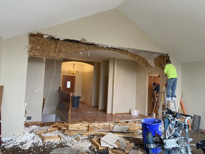 Crew removing interior walls for open concept conversion at same home